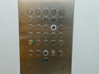A highly polished stainless steel elevator control panel that features clearly labeled buttons corresponding to the numbers 1 through 12, providing easy access to various floors