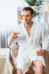 Beauty or body treatment spa salon vacation lifestyle concept with man wearing bathrobe relaxing...
