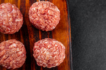 Meatballs raw meat pork, beef, chicken fresh delicious gourmet food background on the table rustic...