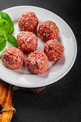 Meatballs raw meat pork, beef, chicken fresh delicious gourmet food background on the table rustic...