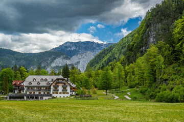 Alpine hotel in green valley with mountain view
