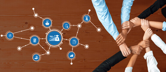 A diverse group of professionals collaborates around a table, focusing on tax planning and...