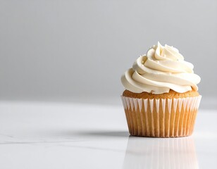 Creamy vanilla cupcake on a marble surface