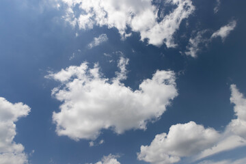 beautiful blue sky with lush white clouds in sunny bright weather