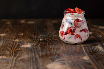 yogurt with cherry flavor and berry slices, glass jar with cherry yogurt with fresh red cherries...