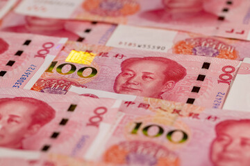 Chinese one hundred yuan in ultraviolet light, the obverse of genuine Chinese yuan money stacked on...