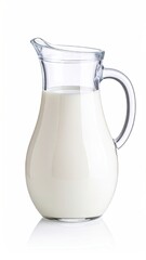 Clear glass milk pitcher, full of white milk