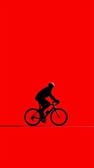 Fototapeta premium Cyclist silhouette on red minimalist background, strong contrast conceptual image