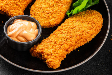 Fish sticks fishs shaped breaded fish nuggets fast food fresh delicious gourmet food background on...