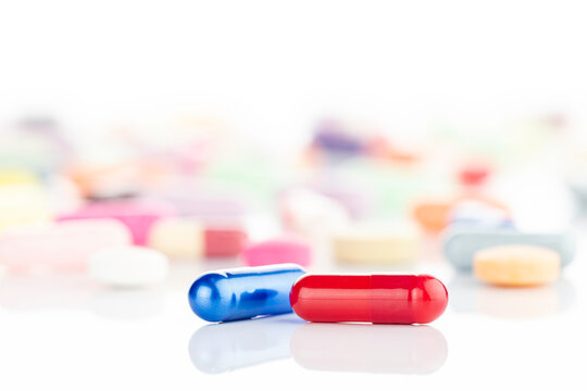 Red and blue pills representing a critical choice. A concept for medicine, healthcare, treatment, and making a difficult decision. isolated on white background