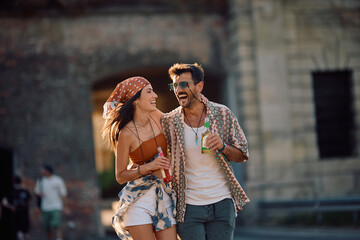 Cheerful couple having fun on open air music festival in summer.