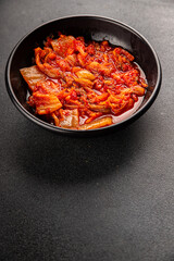 Kimchi pickled cabbage salad spicy savory vegetables fresh delicious gourmet food background on the table rustic food top view copy space vegetarian and vegan food