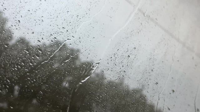 rain on the window in a moving transport. Raindrops on the glass in a train