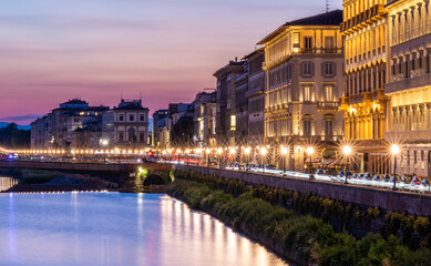 Florence at night on the banks of the Arno River, Italy