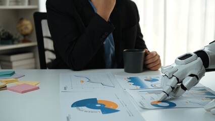 A business professional contemplates analysis in a modern office while interacting with charts and...