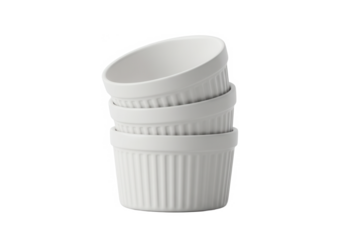 Stacked white ramekins on a plain surface for culinary decoration  