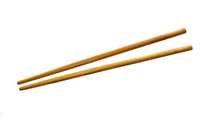 A pair of wooden chopsticks placed on a white background. Two wooden chopsticks made of wood. Wooden chopsticks are tools for eating. Wooden chopsticks. Viewed from above.
