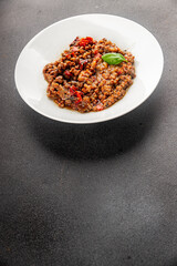Lentil dish vegetables and roasted peppers savory vegetable fresh vegetarian and vegan food gourmet food background on the table rustic food top view copy space keto and paleo diet
