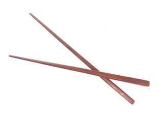 A pair of wooden chopsticks placed on a white background. Two wooden chopsticks made of wood. Wooden chopsticks are tools for eating.