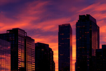 Skyline Silhouette at Dusk: A breathtaking view of modern skyscrapers is set against the vibrant colors of a sunset sky, evoking feelings of awe and urban grandeur.