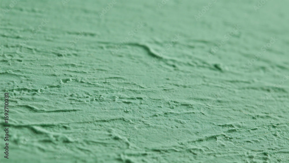 Poster a close up of a textured green surface showing fine details and subtle variations in color and shado