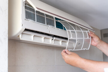 Wall-Mounted AC System Being Cleaned During Home Repair. Disassembled AC Unit During Filter Cleaning