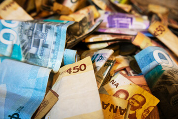 Vibrant colorful photo of mixed Ghanaian cedi notes currency money spread scattered on table desk ground floor surface background