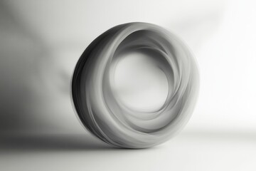 A swirling gray torus shape is isolated on white background with soft lighting