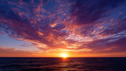 Fototapeta premium Dramatic Sunset over Ocean with Expansive Clouds and Fiery Color Palette
