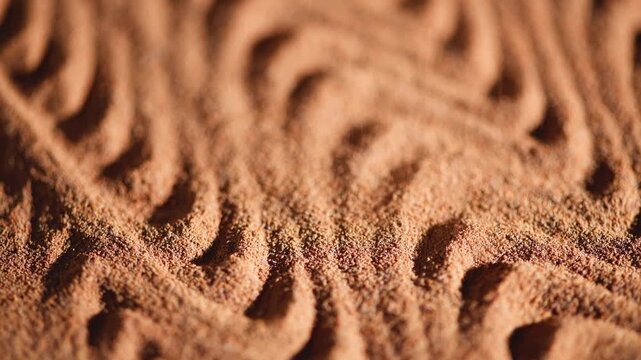 Ground chicory root forms a wavy pattern to create an interesting texture, the powder of a popular decaffeinated coffee substitute, chicory powder falls from top to bottom