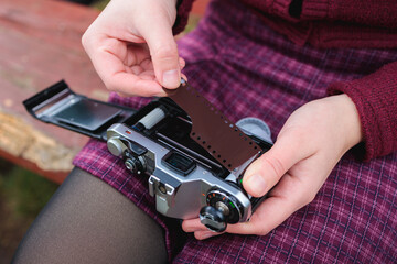 Unrecognizable Young Woman Loading Film into Vintage Camera