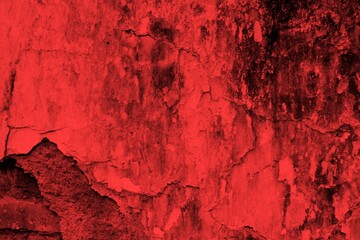 Red background, Rough textured red wall with visible cracks and dark abstract patterns, ideal for...