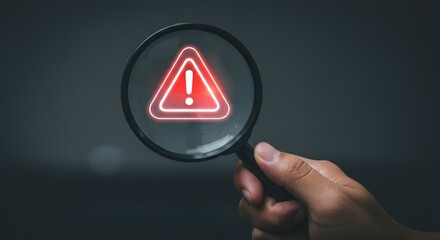 Warning Alert Symbol Under Magnifying Glass – Risk Detection Concept.