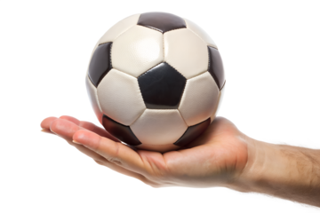 A persons hand gently holding a classic black and white soccer ball, isolated on a transparent background