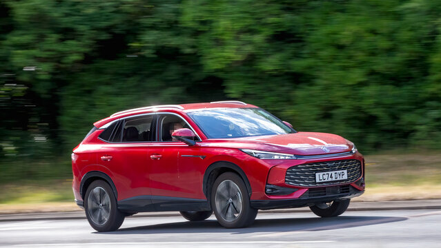Milton Keynes,Bucks,UK - July 17th 2025: 2024 red MG hs Trophy SUV car driving on a British road