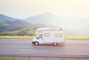 White Camper Van Traveling on Scenic Mountain Highway – Freedom Road Trip and Adventure Concept