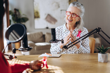 Senior woman speaking about breast cancer prevention during a podcast interview
