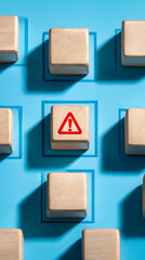 Wooden blocks with warning symbol on blue background alert caution