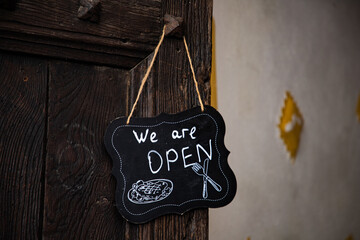 we are open sign on restaurant door