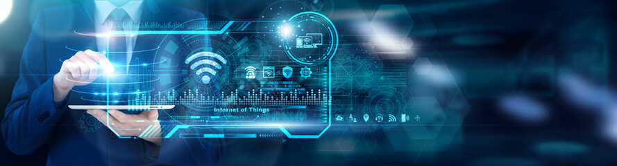 IoT Architect using tablet analyzing Internet of Things sensor anomaly rates and device...