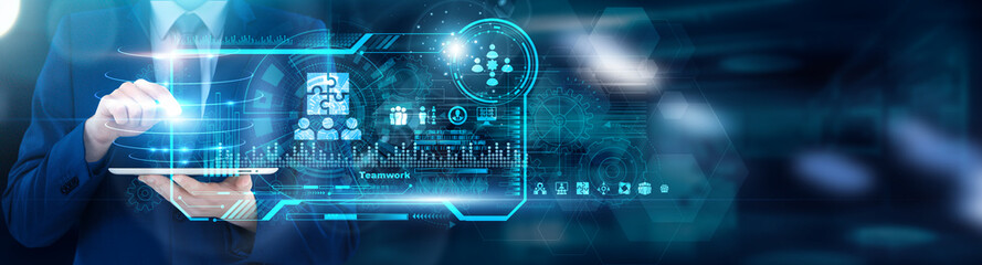 Collaboration Specialist using tablet analyzing Teamwork cross-functional dependency maps and...
