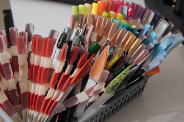 Palette for nail polish in box. Soft focus. Nail polish samples