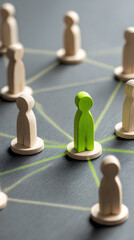 Obraz premium Wooden figures connected by green lines on dark surface people connection