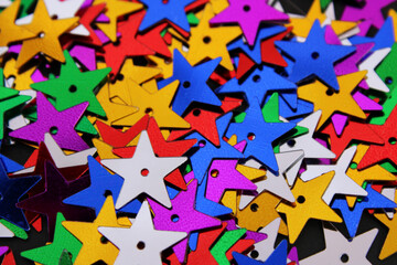 Background full of colorful star-shaped sequins