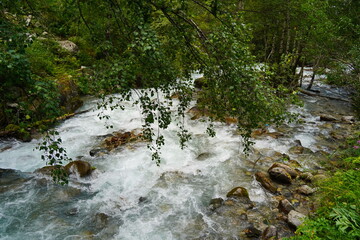 A mountain river with stone boulders in the Alma-Arasan gorge. Ile-Alatau National Park.