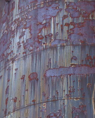 A Weathered, Rusty Steel Wall with Rivets, Bolts, and Panels
