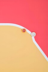 Flat lay of dried orange slice against pink and yellow background for food blog