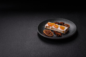 Nougat or white caramel with hazelnuts and pistachios and citrus pieces. White nougat with nuts