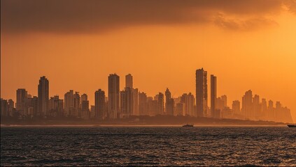Silhouette city skyline at sunset over water