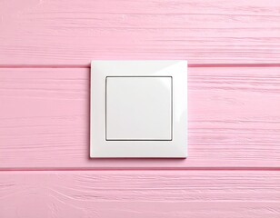 White electrical switch on pink wooden surface